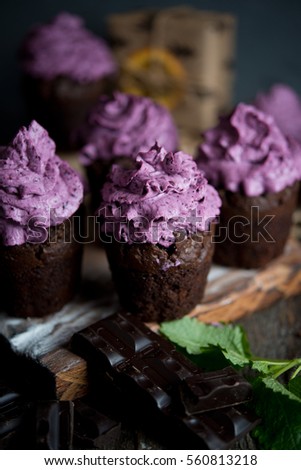 Homemade chocolate muffin with blueberry cream