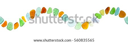 sea glass peices border in shape of waves on white Royalty-Free Stock Photo #560835565