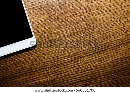 Composition with phone on the wooden table