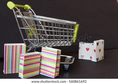 bank debit card with shopping trolly and shopping bangs on black background horizontal