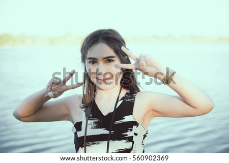 Portrait of asian woman show two fingers outdoor vintage style