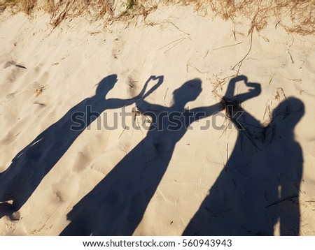 people shadows on the sand love