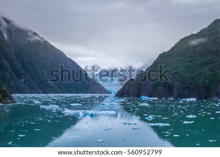 Light in nature, picture of an alaskan glacier with mountains on the side
