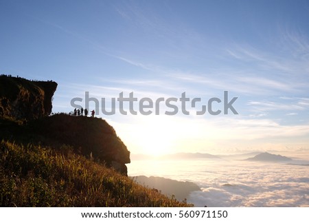 Silhouette peoples on top the mountain view point sunrise and sea of mist, Phu Chi Fa, Chiang Rai, Thailand.