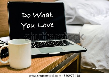BE WHAT YOU LOVE wording on laptop screen with bedroom interior as background. Motivation and positive wishes business economy finance security dateline scheduling concept