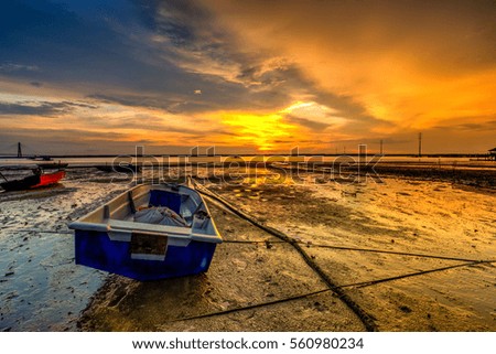 Beautiful A long exposure picture of sunset over a fishing boat