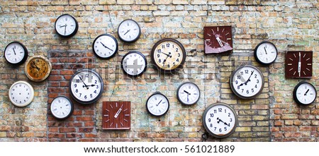 Collection of vintage clock hanging on an old brick wall Royalty-Free Stock Photo #561021889