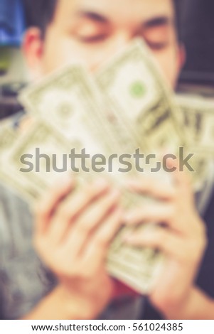 Blurred abstract background of man happy with money