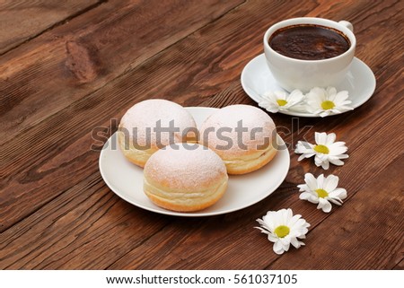 
tempting coffee with sweet donuts in among the fragrant flowers