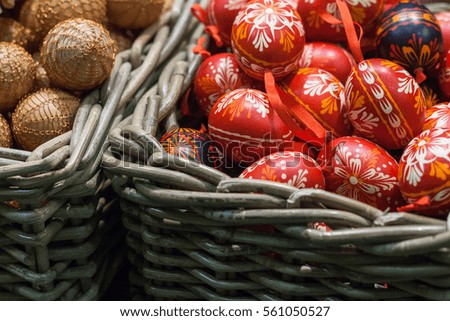 Many Easter eggs lie in the form of toys in the basket. Celebratory background.