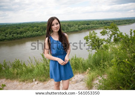 Attractive woman posing against the backdrop of forest. slope of the horizon