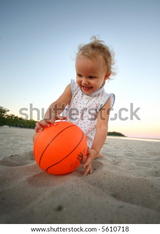 Baby girl plays with a sand