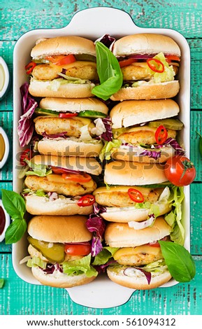 Mini hamburgers with chicken burger, cheese and a vegetables. Flat lay. Top view.