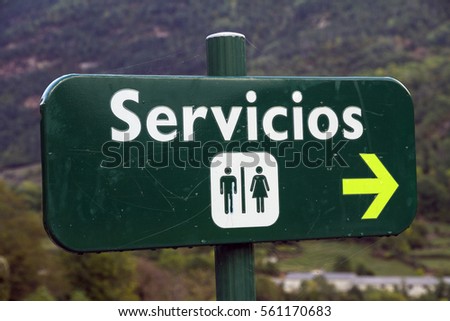 Men and women public restroom and toilet signs with direction arrow symbol, spain
