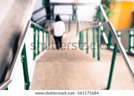 Blur image of corridor and people in public subway train platform for background usage. Vintage tone.