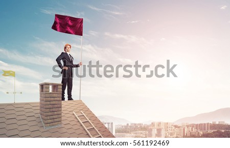 Businessman standing on house roof and red holding flag. Mixed media