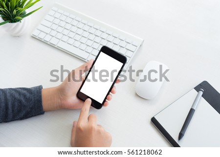 hand hold phone mobile and touching on workspace table
