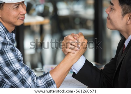 Arm wrestling of business people
