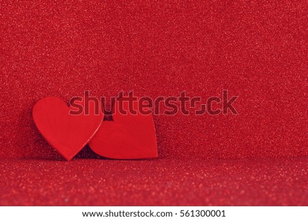 Valentines day background. Wooden red hearts on red shiny background