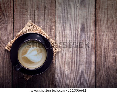 cup of cappuccino coffee on the old vintage wooden table