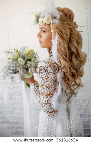 beautiful blonde woman with a wreath of white flowers and bouquet