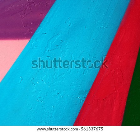 photo of bold and saturated patterns painted over wall. street photography
