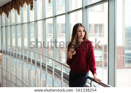 beautiful business woman writing sms on a mobile phone