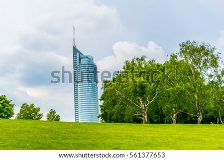 Millenium tower behind a hill in Vienna, Austria.