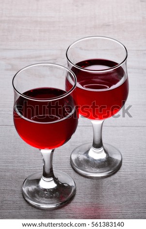 glass of red wine. A couple of glasses of wine on a light wooden background