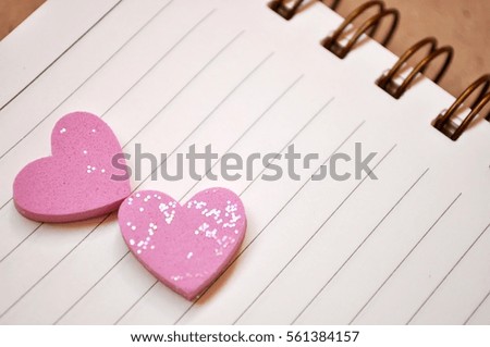 Pink heart on white notebook for background