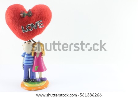Doll women and men A couple stands with red hearts for ages with the word loveon a white background Valentine's Day.