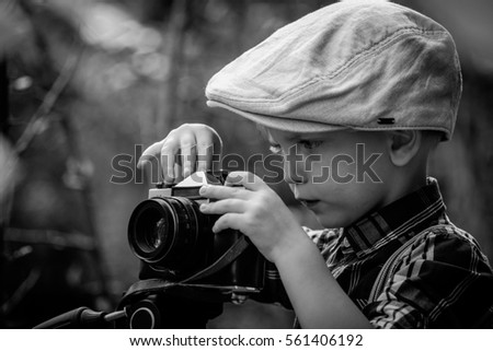 Child with vintage camera. Retro style.