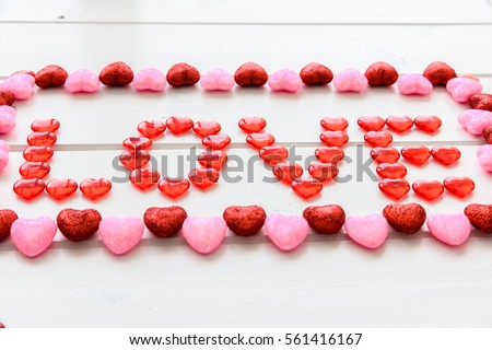 Valentines Day background with love text on grunge wooden desk.