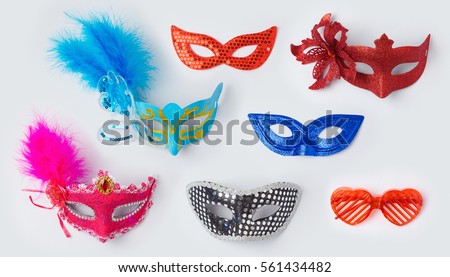 Carnival or mardi gras masks on white background for mock up template design. View from above. Flat lay Royalty-Free Stock Photo #561434482