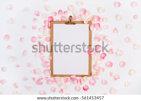 Clipboard mock up and pink rose petals pattern. Flat lay, top view