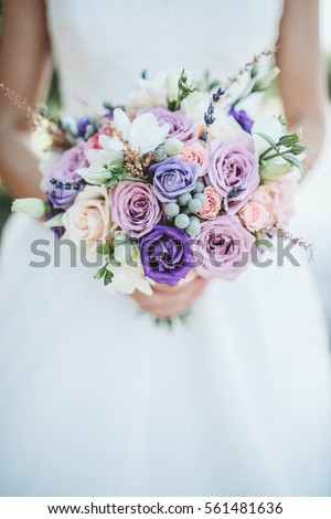 Beauty wedding bouquet in bride's hands