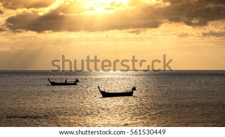 Beautiful sunset landscape at sea and orange sky above with boat. Phuket, Thailand.