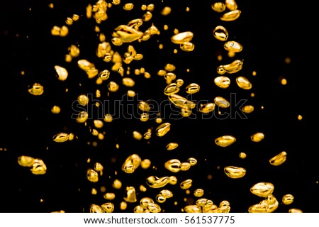 Air bubbles gold on a black background.