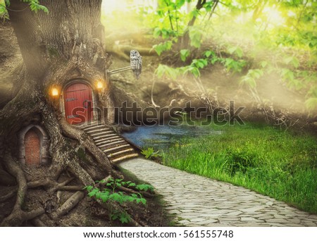 Fairy tree house in fantasy forest with stone road Royalty-Free Stock Photo #561555748