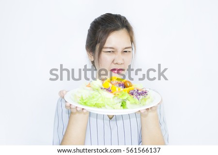 Asian female do not like vegetable salad, Concept Do not like to eat vegetables