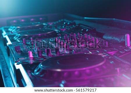 DJ sound equipment at nightclubs and music festivals, EDM, future house music and so on. Parties concept, sound technique. DJ playing on the best, famous CD players. Royalty-Free Stock Photo #561579217