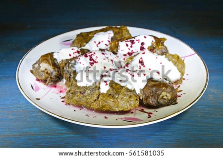 Grape leaves stuffed with minced meat and rice. Dolma with sauce