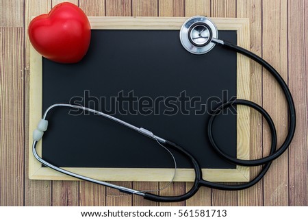 Red heart, stethoscope on chalk board with wooden background, health medical technology information concepts