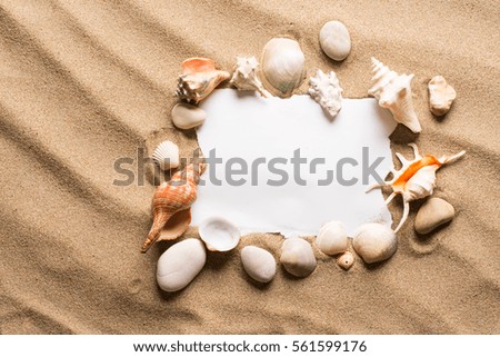 Message in torn paper on the beach. Summer background with hot sand
