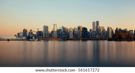 Vancouver downtown architecture and boat with water reflections at sunset panorama