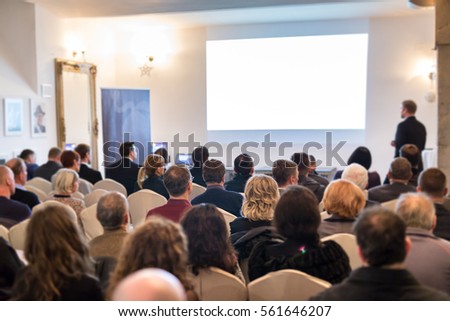 Audience at the conference hall. Speaker giving a talk on corporate Business Conference. Business and Entrepreneurship event. Royalty-Free Stock Photo #561646207