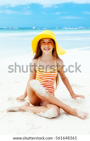 10 years old child girl playing on the beach on tropical island. Philippines, Boracay.
