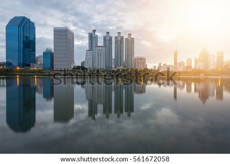 City building with water reflection before sunset background