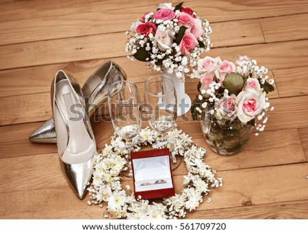 Wedding day scene. Bride equipment. Wedding shoes, flowers and wedding rings in box. Wedding concept.