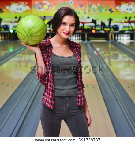 Girl  playing bowling. The concept of active rest. Bowling ball